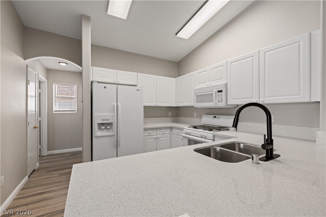 8777 Roping Rodeo Avenue, Unit 101 Las Vegas, NV 89178 - Photo 7 of 25 Culinary aspirations come alive in this kitchen featuring abundant white cabinetry and sleek counters.