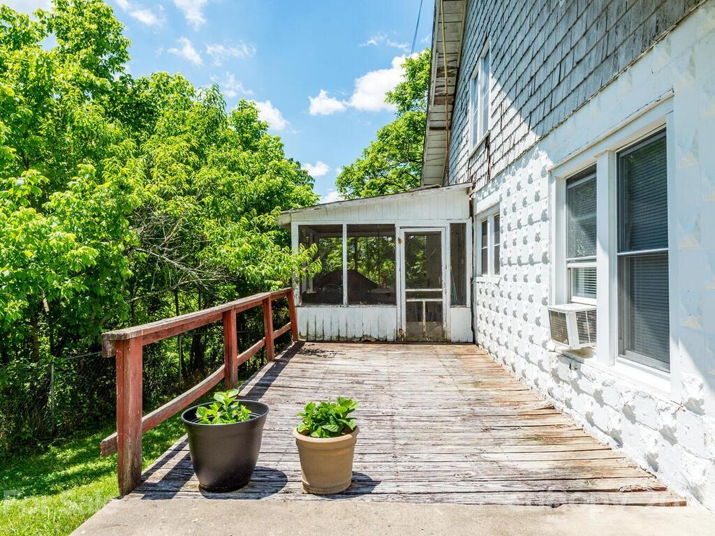 131 Frisby Road Marshall, NC 28753 - Photo 15 of 32 a view of a house with a flower garden