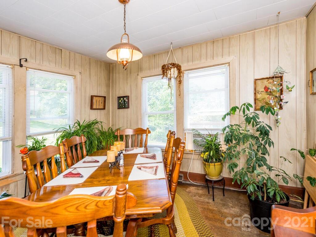 131 Frisby Road Marshall, NC 28753 - Photo 18 of 32 a dining room with furniture a chandelier and large windows