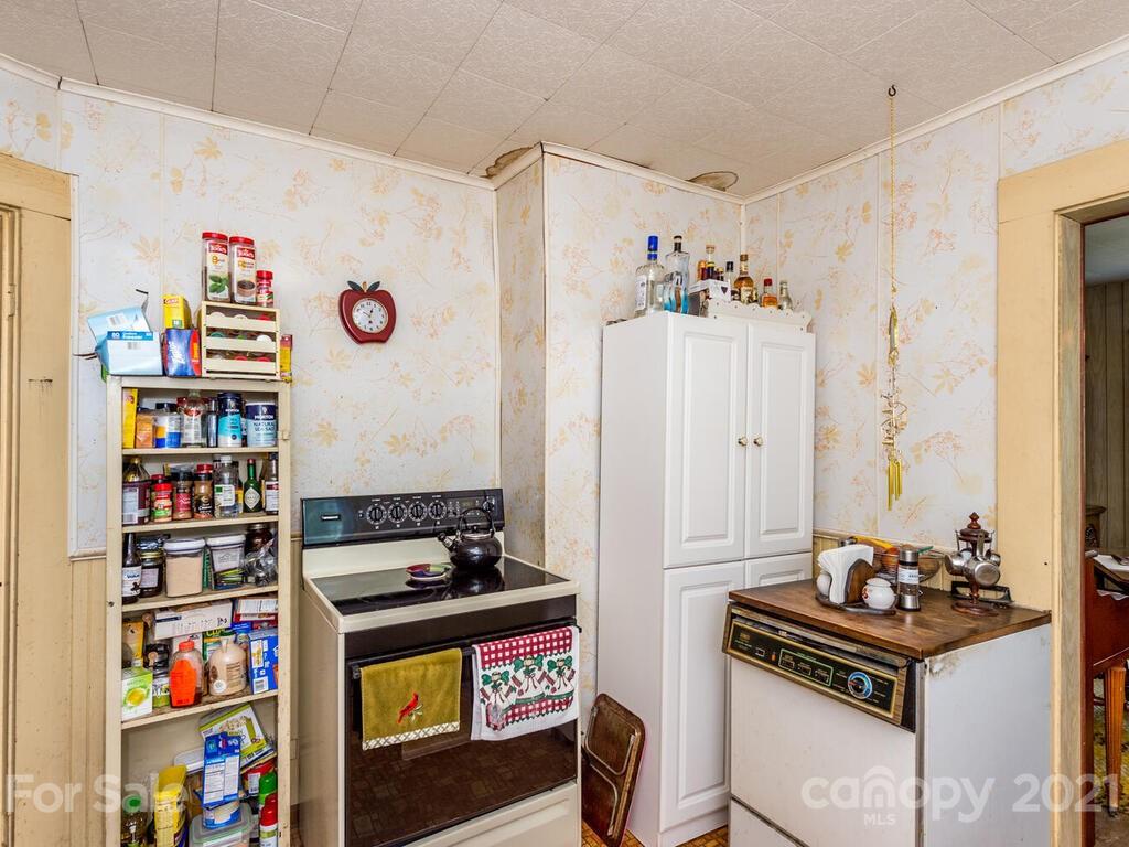 131 Frisby Road Marshall, NC 28753 - Photo 21 of 32 a kitchen with stainless steel appliances a stove a refrigerator and a bookshelf