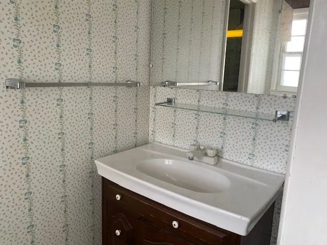 a living room with furniture a air conditioner vent and a window