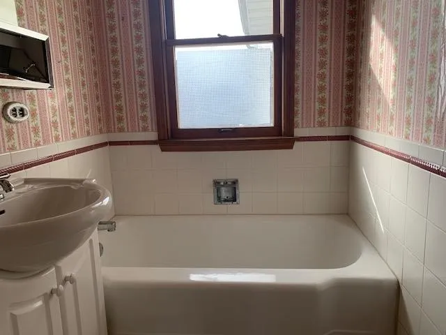 a front view of house with yard and trees around