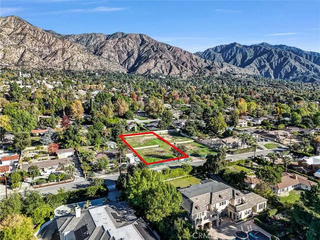 an aerial view of a houses with a yard