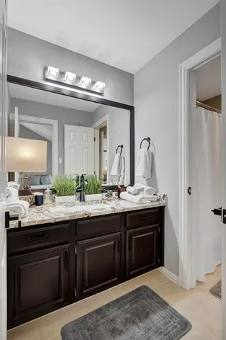 a bathroom with double sink and a mirror