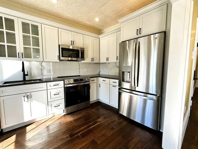 a kitchen with stainless steel appliances a refrigerator sink and microwave