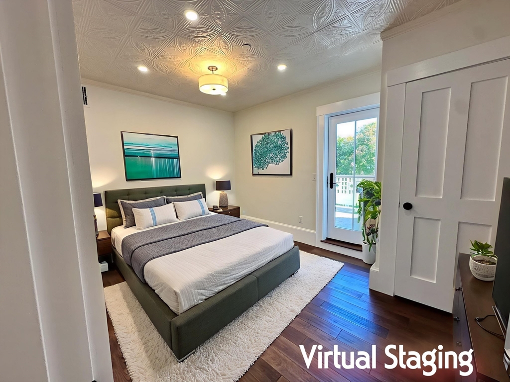 11 Lowell Road, Unit 2B Groton, MA 01450 - Photo 11 of 19 a bedroom with a bed and wooden floor