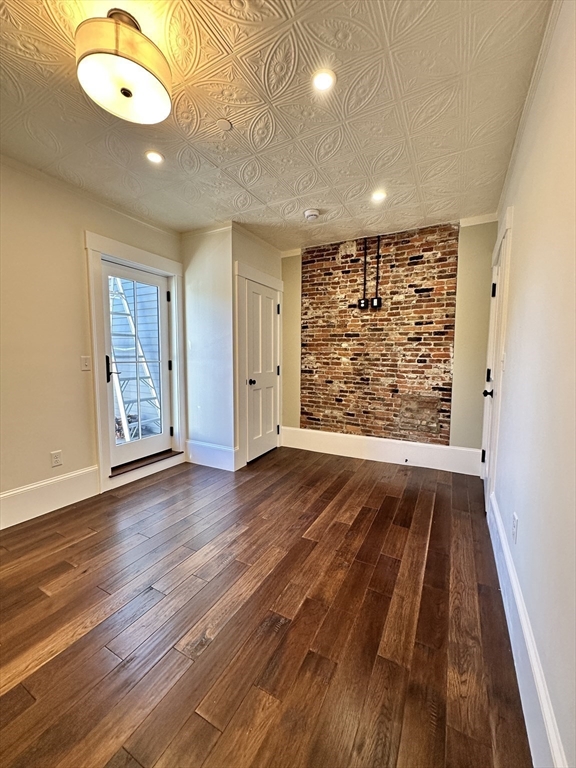 11 Lowell Road, Unit 2B Groton, MA 01450 - Photo 13 of 19 an empty room with wooden floor and windows