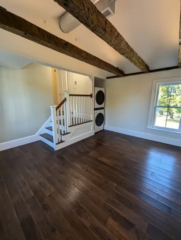 a view of entryway with wooden floor and stairs