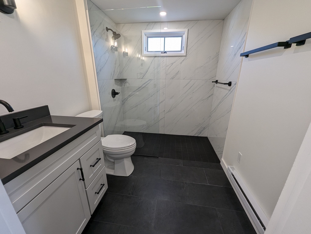11 Lowell Road, Unit 2B Groton, MA 01450 - Photo 19 of 19 a bathroom with a granite countertop sink toilet and shower