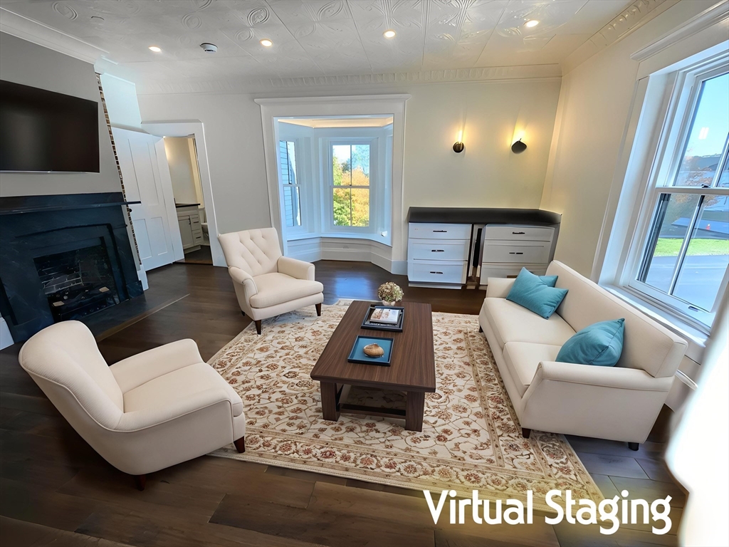 11 Lowell Road, Unit 2B Groton, MA 01450 - Photo 3 of 19 a living room with furniture a fireplace a flat screen tv and a large window