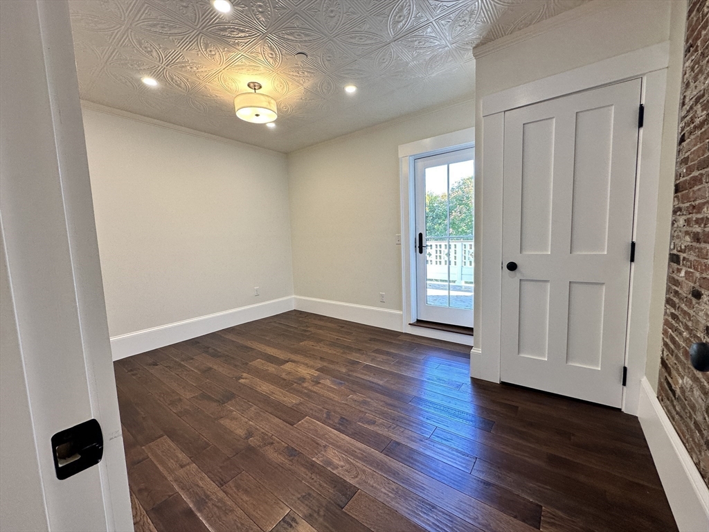 11 Lowell Road, Unit 2B Groton, MA 01450 - Photo 10 of 19 an empty room with wooden floor and windows