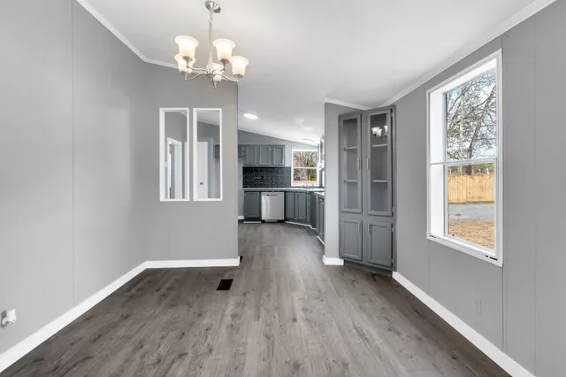 a view of livingroom with chandelier and wooden floor