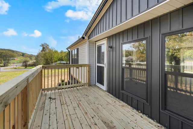 a balcony with wooden floor and outdoor space