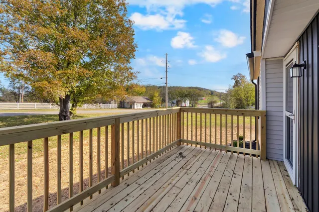 a view of a balcony with wooden floor