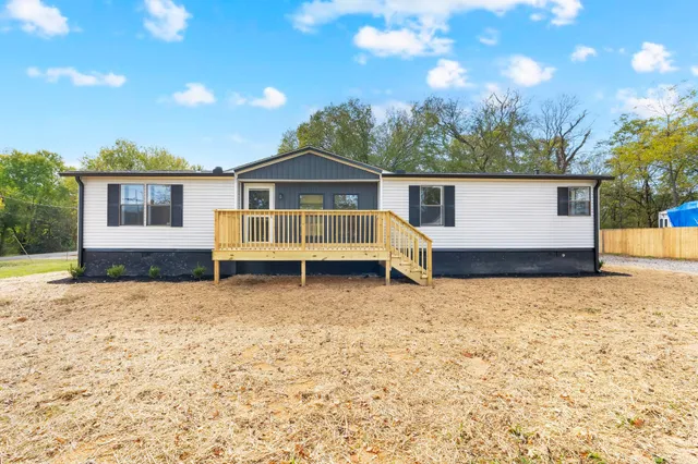 a view of house with a yard