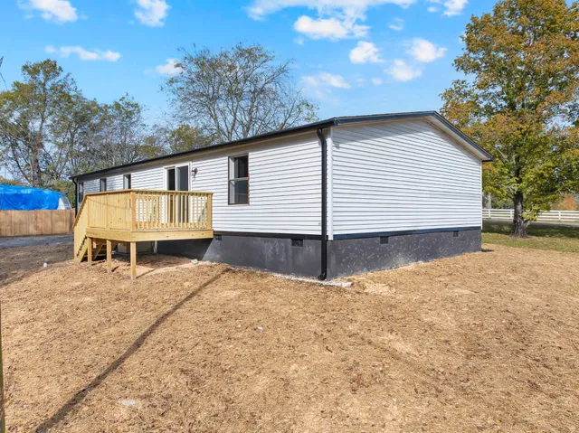 a view of a house with a yard and garage