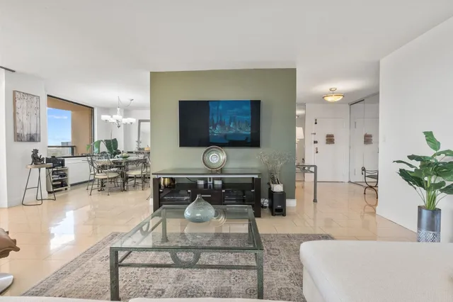 a view of a dining room with furniture and a chandelier