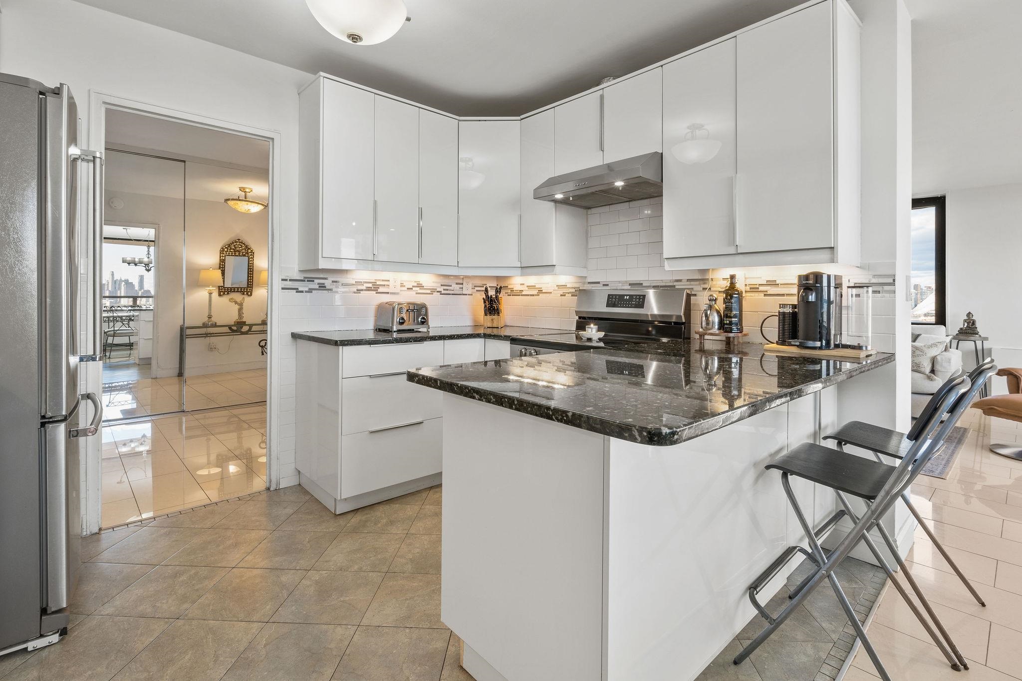 380 Mountain Road, Unit 612 Union City, NJ 07087 - Photo 16 of 45 a kitchen with stainless steel appliances granite countertop a sink and cabinets