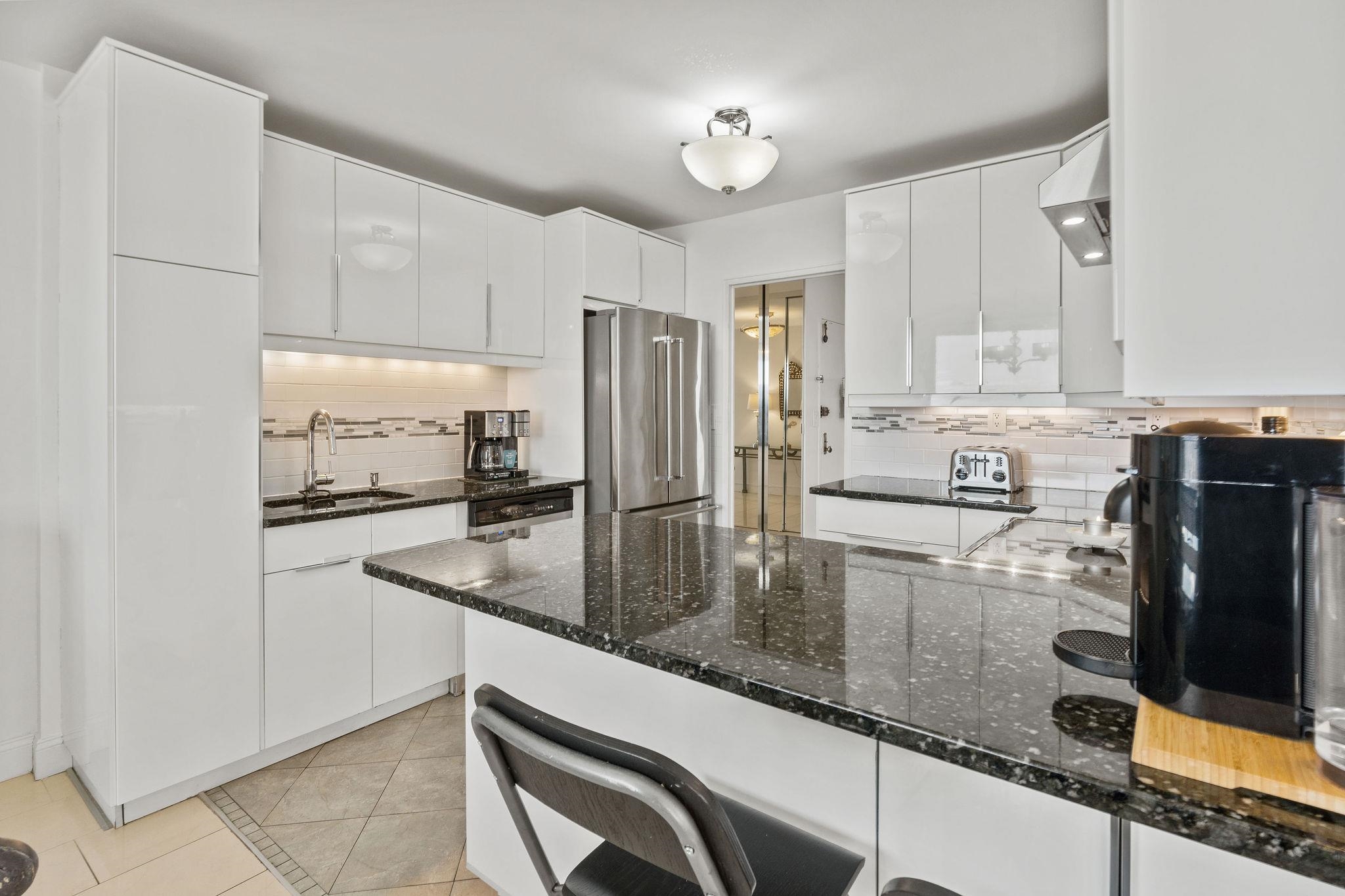 380 Mountain Road, Unit 612 Union City, NJ 07087 - Photo 17 of 45 a kitchen with stainless steel appliances granite countertop a sink refrigerator and cabinets