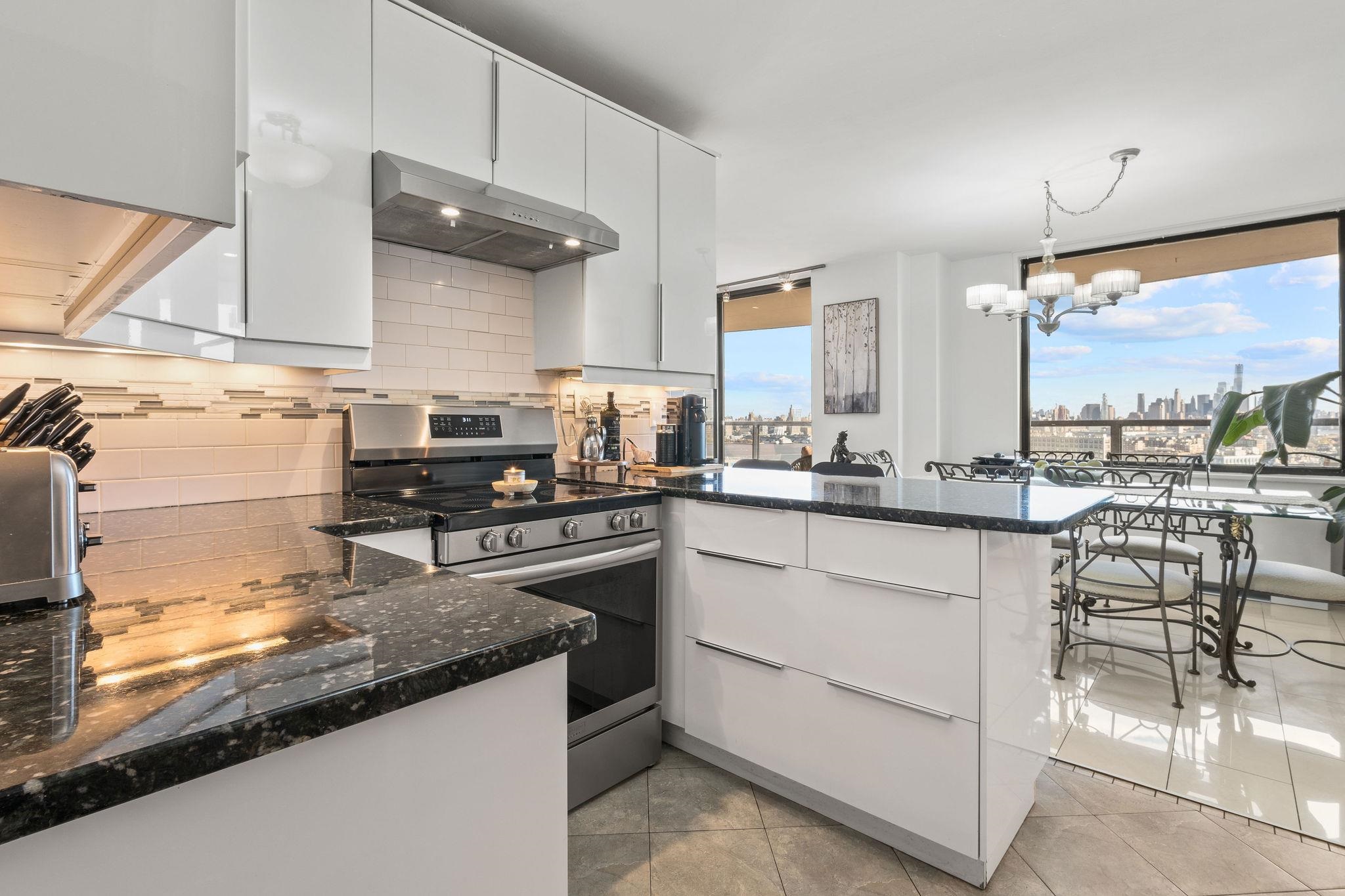 380 Mountain Road, Unit 612 Union City, NJ 07087 - Photo 18 of 45 a kitchen with stainless steel appliances granite countertop a sink stove and cabinets