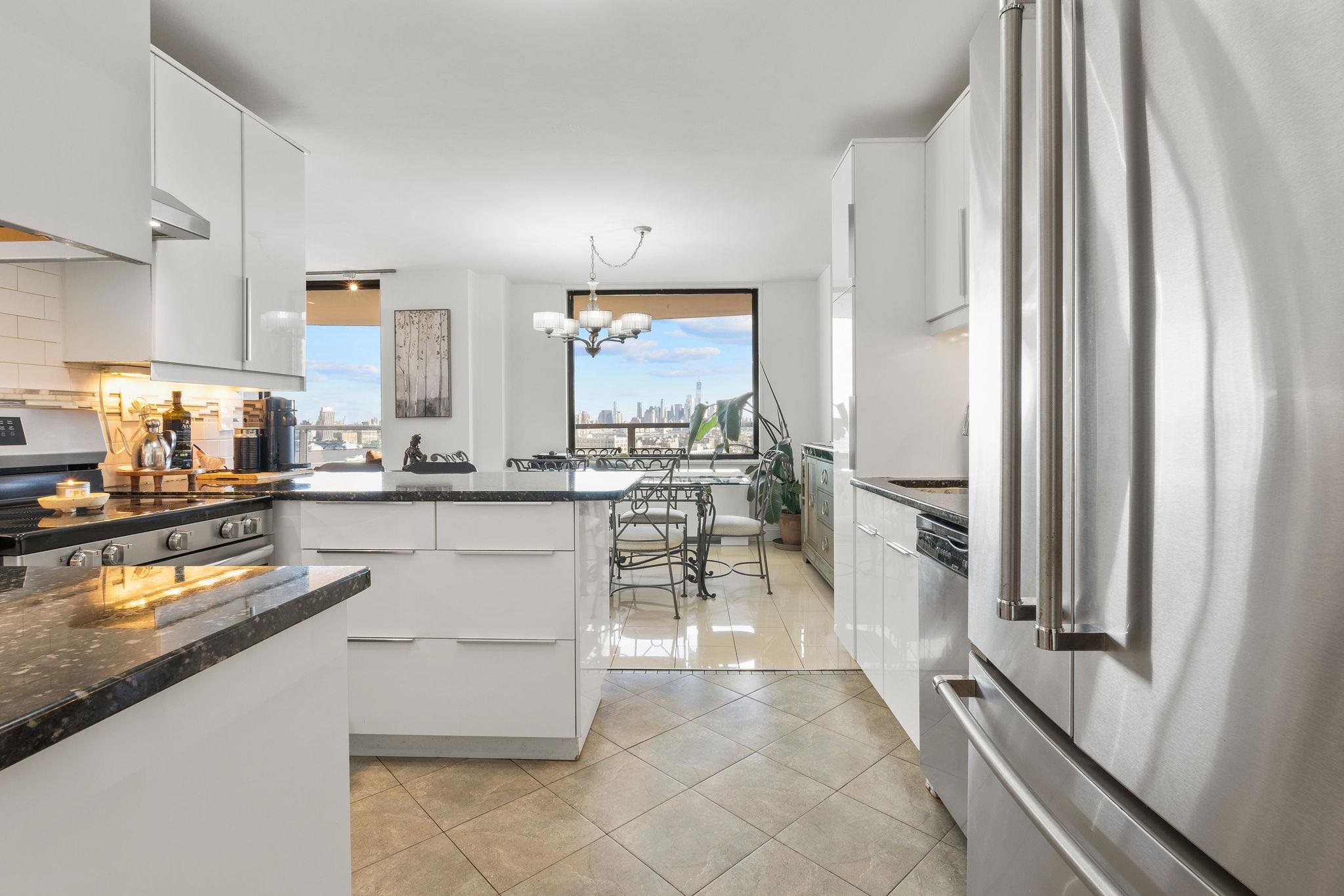 380 Mountain Road, Unit 612 Union City, NJ 07087 - Photo 19 of 45 a kitchen with stainless steel appliances granite countertop a refrigerator and a stove