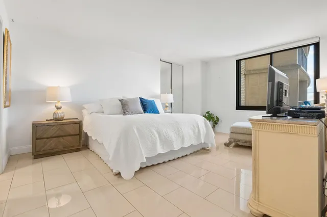 a bedroom with a bed and a television