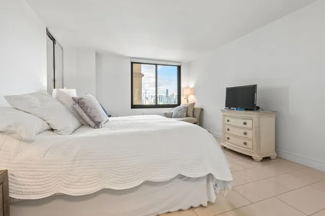 a bedroom with a bed and flat screen tv