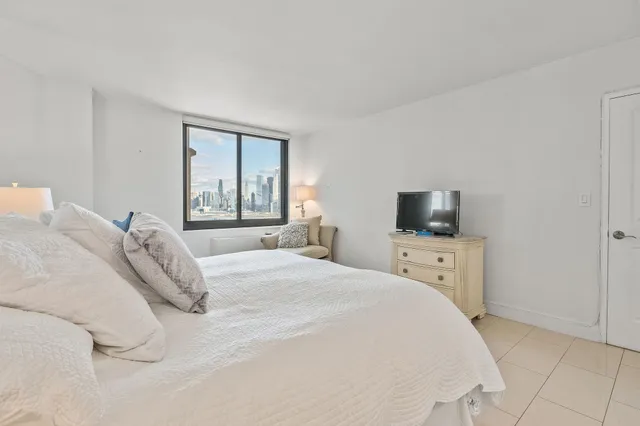 a bathroom with a sink a toilet a mirror and shower