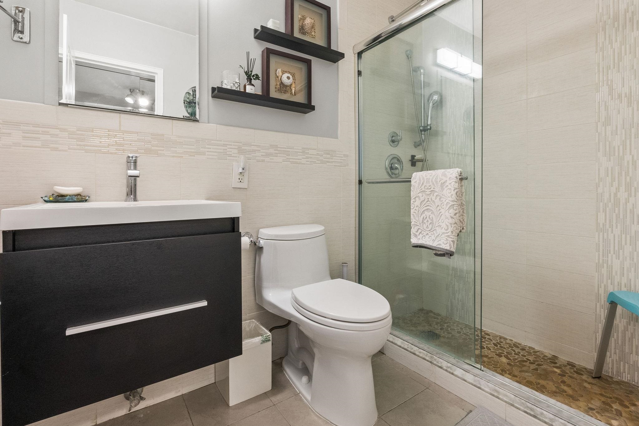 380 Mountain Road, Unit 612 Union City, NJ 07087 - Photo 28 of 45 a bathroom with a sink a toilet a mirror and shower