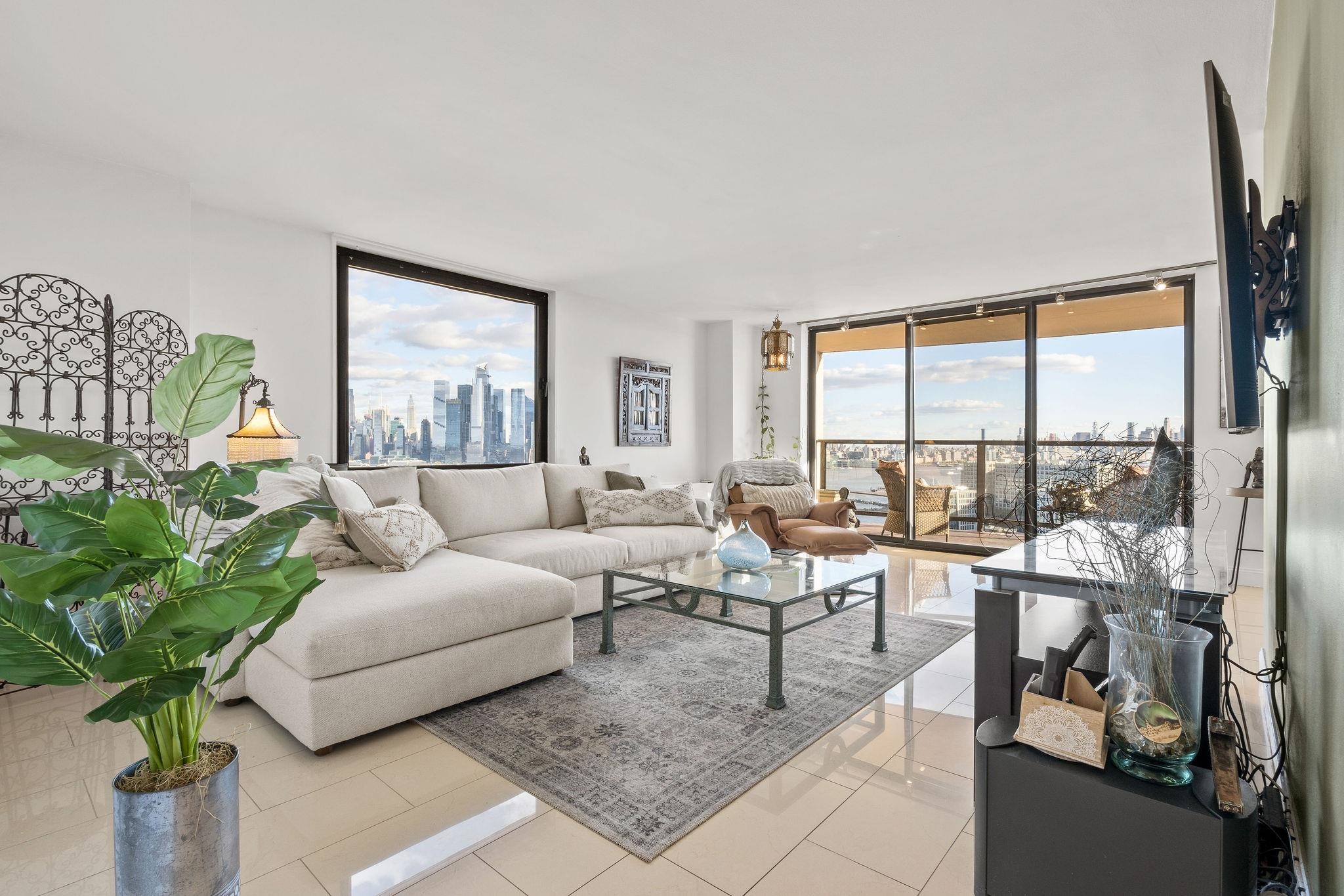 380 Mountain Road, Unit 612 Union City, NJ 07087 - Photo 3 of 45 a living room with furniture and a large window with potted plants