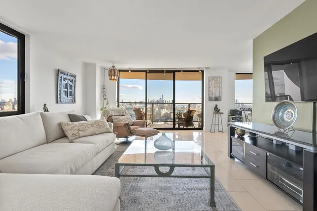 a living room with furniture and large windows