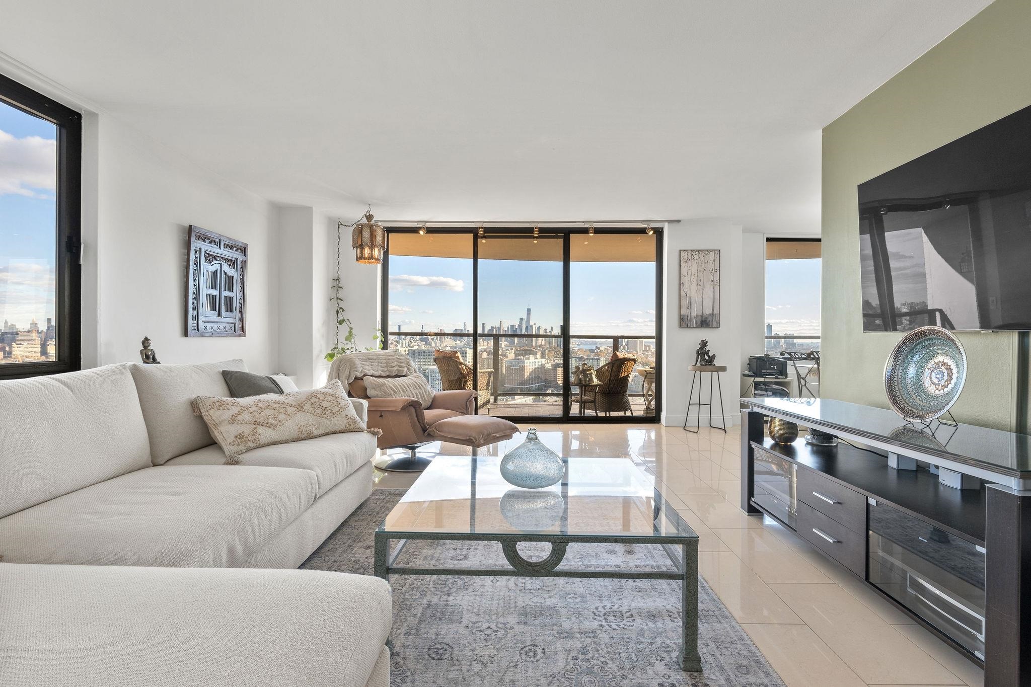 380 Mountain Road, Unit 612 Union City, NJ 07087 - Photo 4 of 45 a living room with furniture and large windows