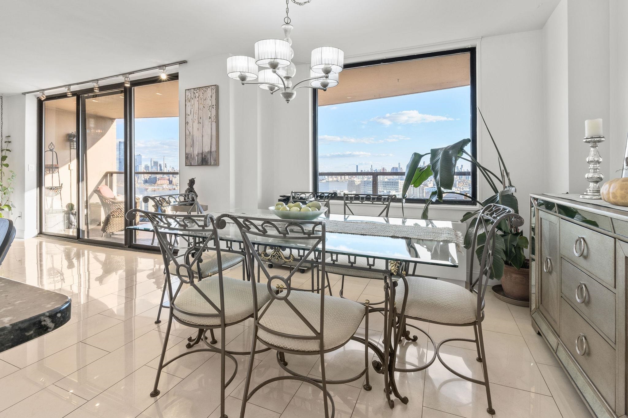 380 Mountain Road, Unit 612 Union City, NJ 07087 - Photo 9 of 45 a view of a dining room with furniture large windows and wooden floor