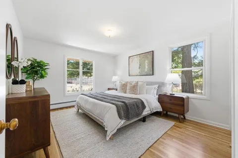 a bedroom with a bed and a potted plant
