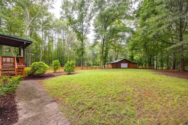 a view of a backyard with a garden and entertaining space