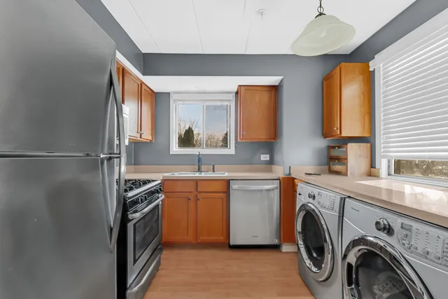 a utility room with sink dryer and washer
