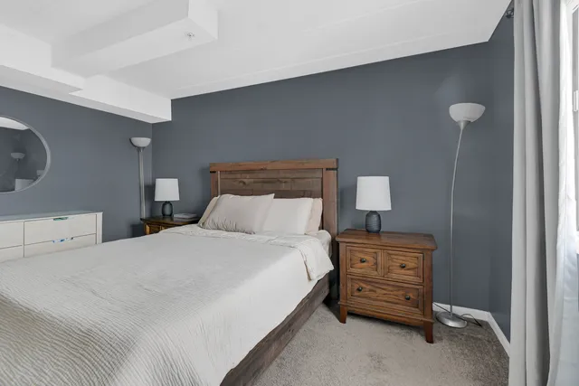 a bedroom with a bed and a night stand