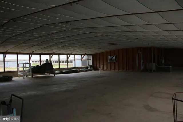 a kitchen with a sink and chairs