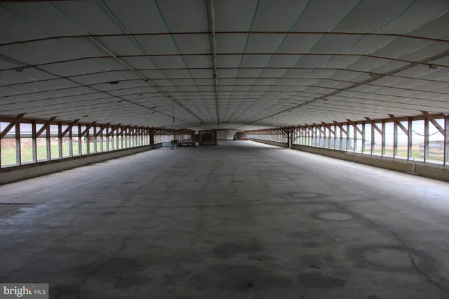 a kitchen with a sink a stove and chairs