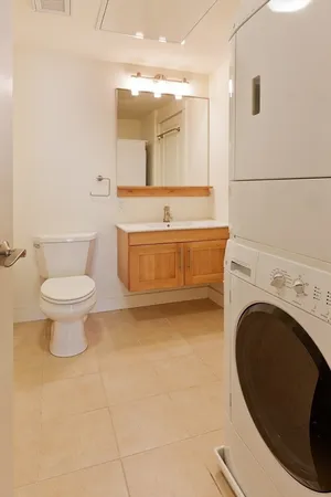 a bathroom with a toilet a sink and mirror