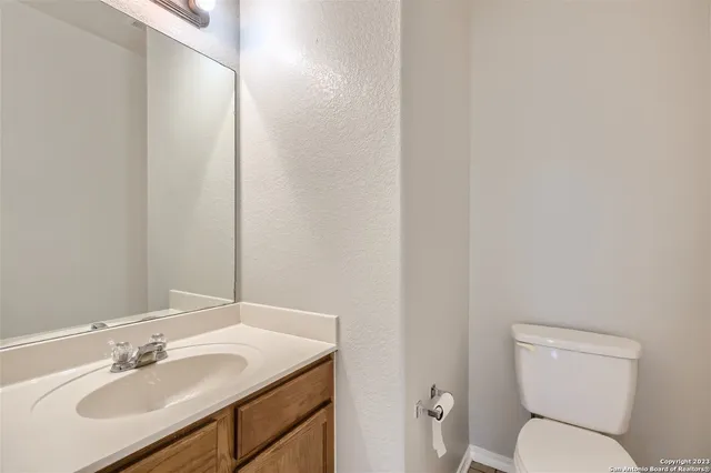 a bathroom with a toilet sink and mirror