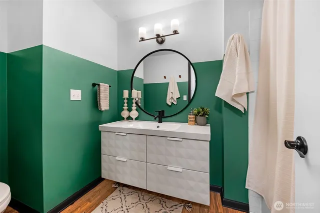 a view of a bathroom with a sink and mirror