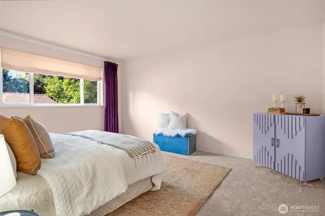 a bedroom with a bed and a large window