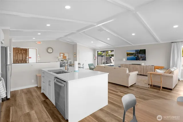 a view of a house with roof deck outdoor seating and city view