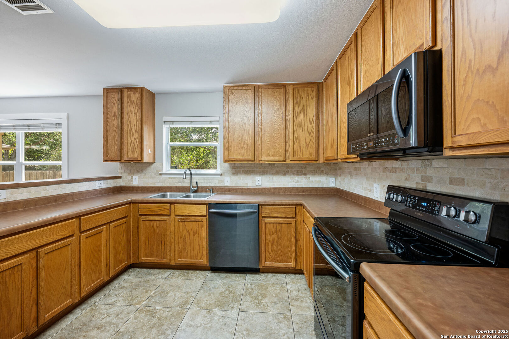 4030 Bear Oak Path San Antonio, TX 78223 - Photo 12 of 31 a kitchen with stainless steel appliances granite countertop a sink stove and cabinets