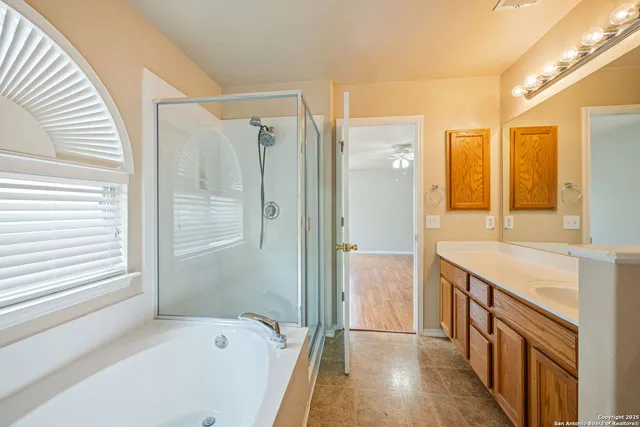a bathroom with a bathtub and a shower
