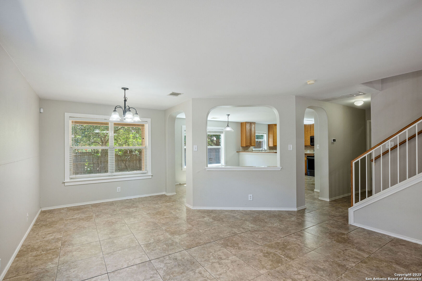 4030 Bear Oak Path San Antonio, TX 78223 - Photo 7 of 31 an empty room with windows and chandelier