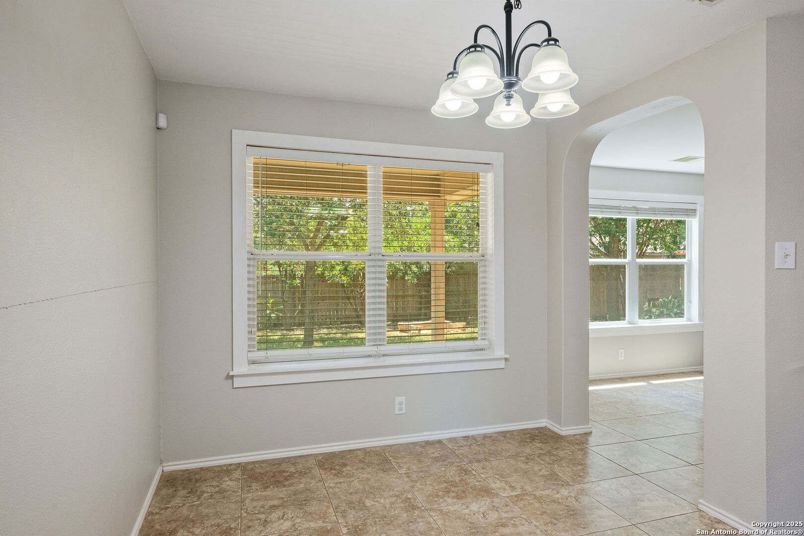 4030 Bear Oak Path San Antonio, TX 78223 - Photo 8 of 31 a view of an empty room with wooden floor and a window
