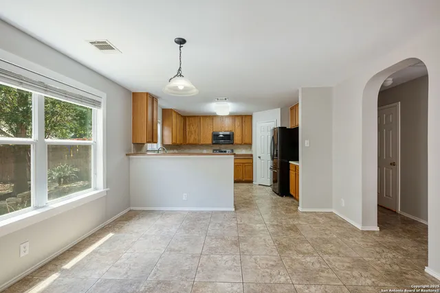 a view of a kitchen with a sink and windows