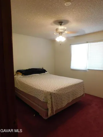 a bedroom with a bed and a table